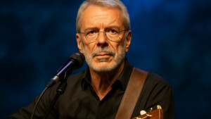 Reinhard Mey mit Gitarre (KI-generiert)