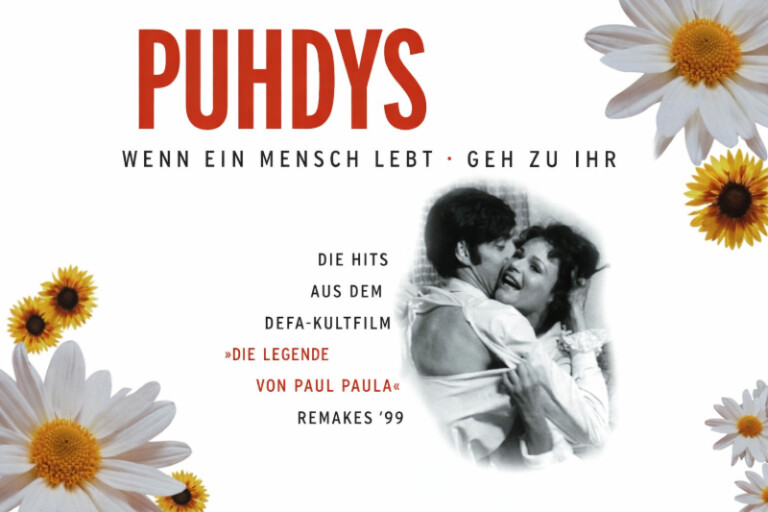 Albumcover der Band Puhdys im 16:9-Format: Oben steht groß „PUHDYS“ in roter Schrift, darunter die Titel „Wenn ein Mensch lebt · Geh zu ihr“. Rechts ist ein schwarz-weißes Bild eines sich umarmenden Paares aus dem Film „Die Legende von Paul und Paula“. Das Design ist mit weißen und gelben Blumen dekoriert, und zusätzlicher Text verweist auf Hits aus dem DEFA-Kultfilm sowie „Remakes ’99“.